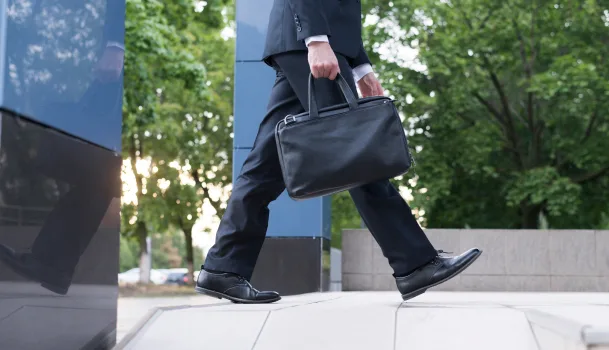 Professional carrying briefcase outdoors