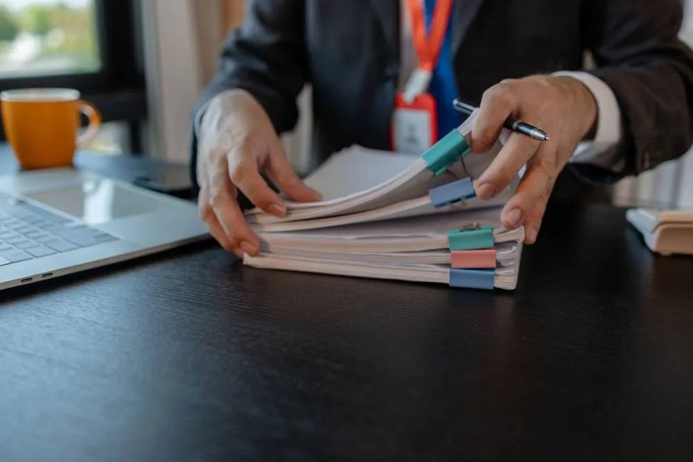 Professional reviewing financial documents at a desk