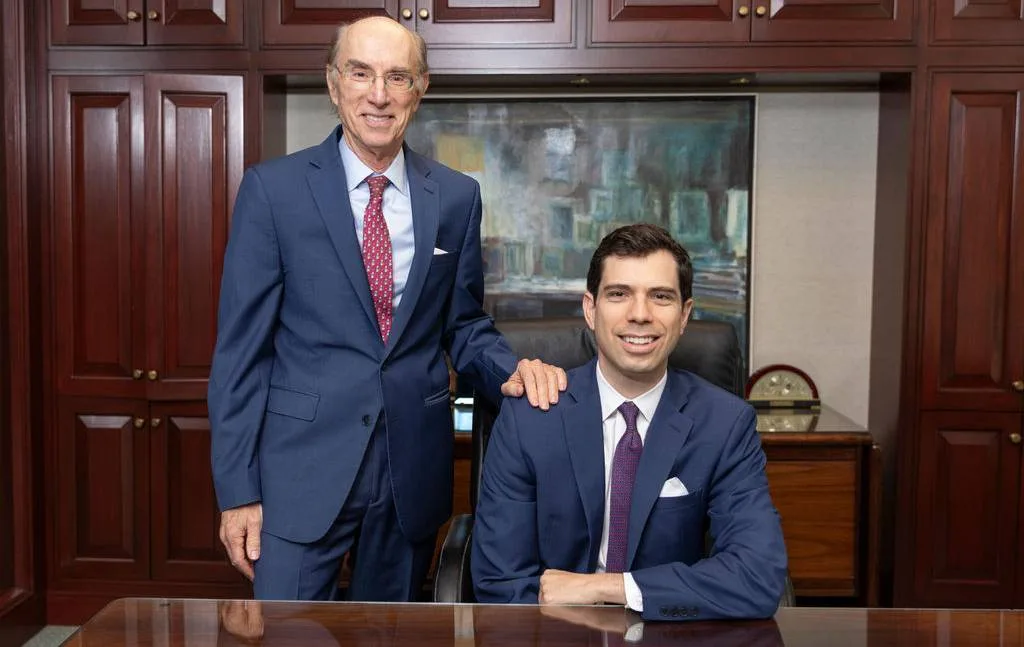 Two professionals standing together in a legal office setting
